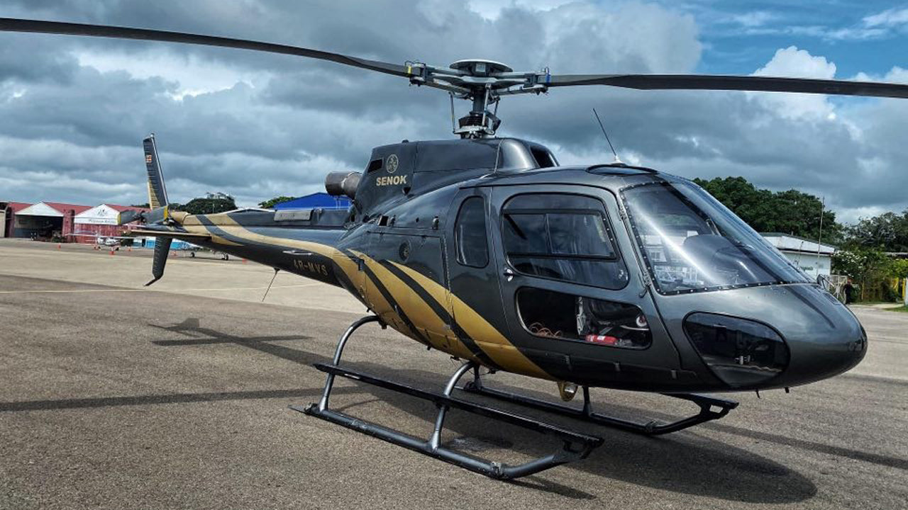 Helicopter on a tarmac with a clear sky background